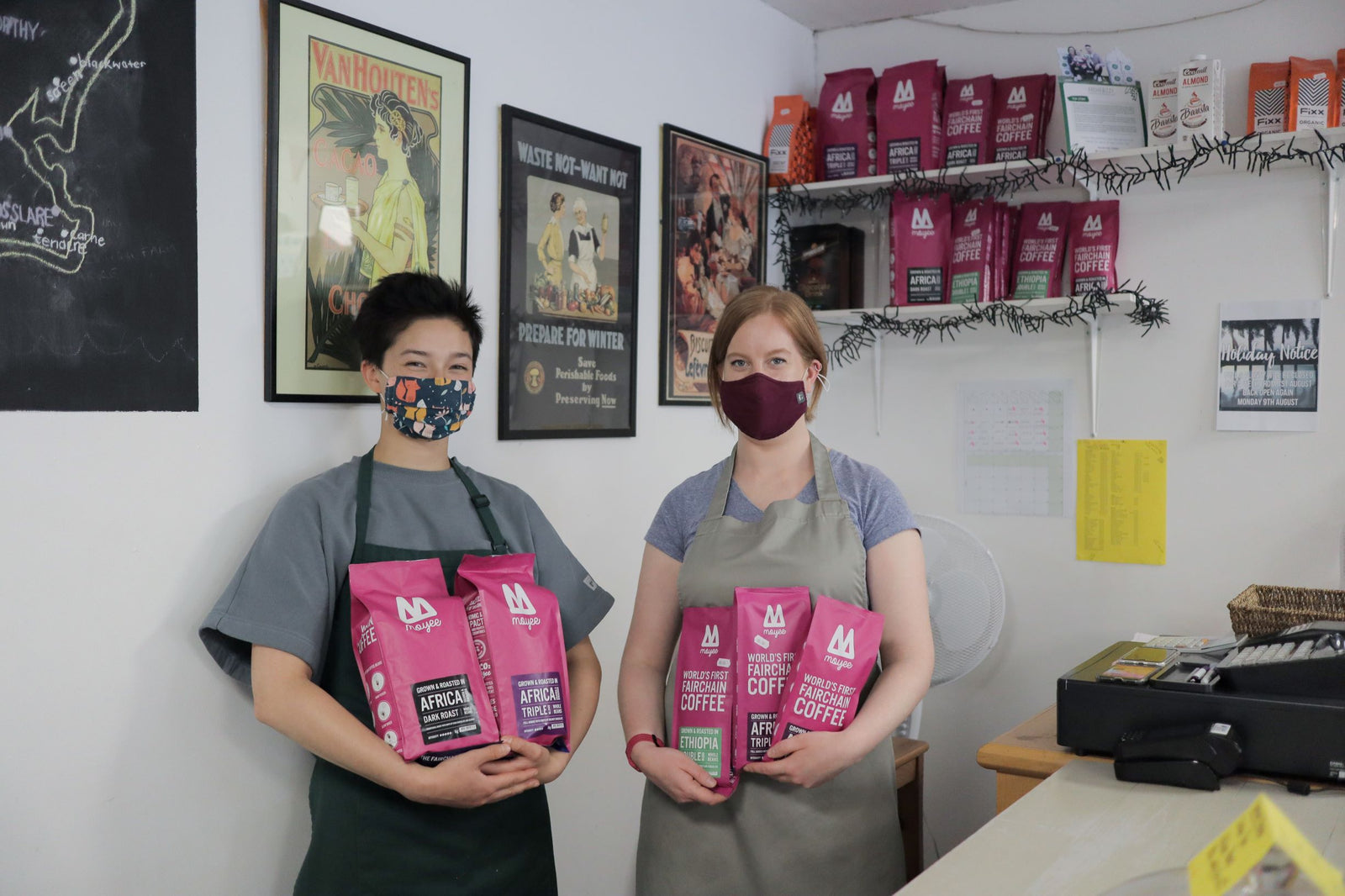 Baristas holding bags