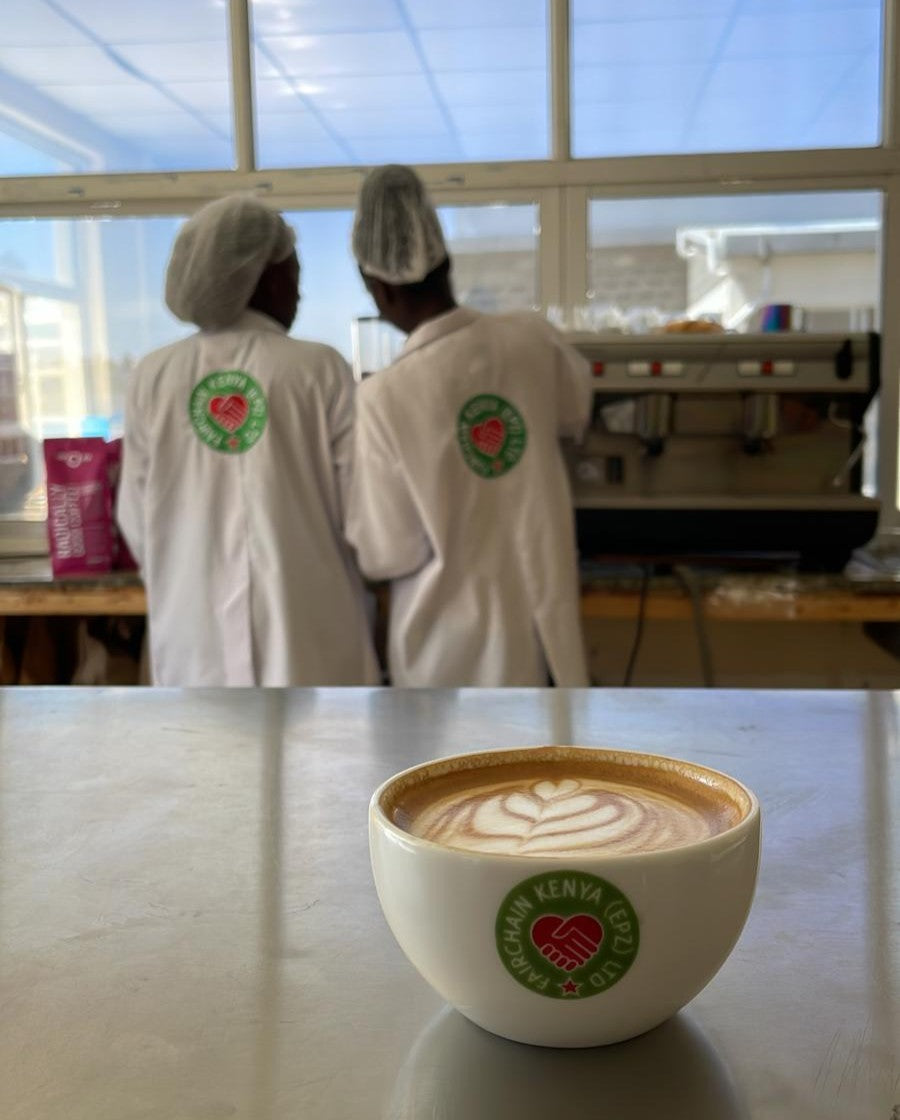 Moyee coffee cup with baristas in the background